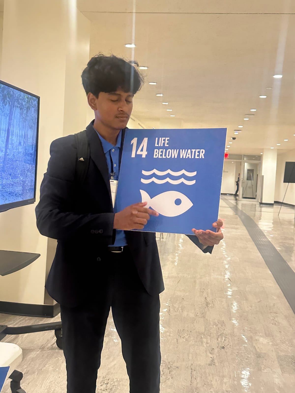 A DTC member with the SDG 14 'Life Below Water' goal at the UN